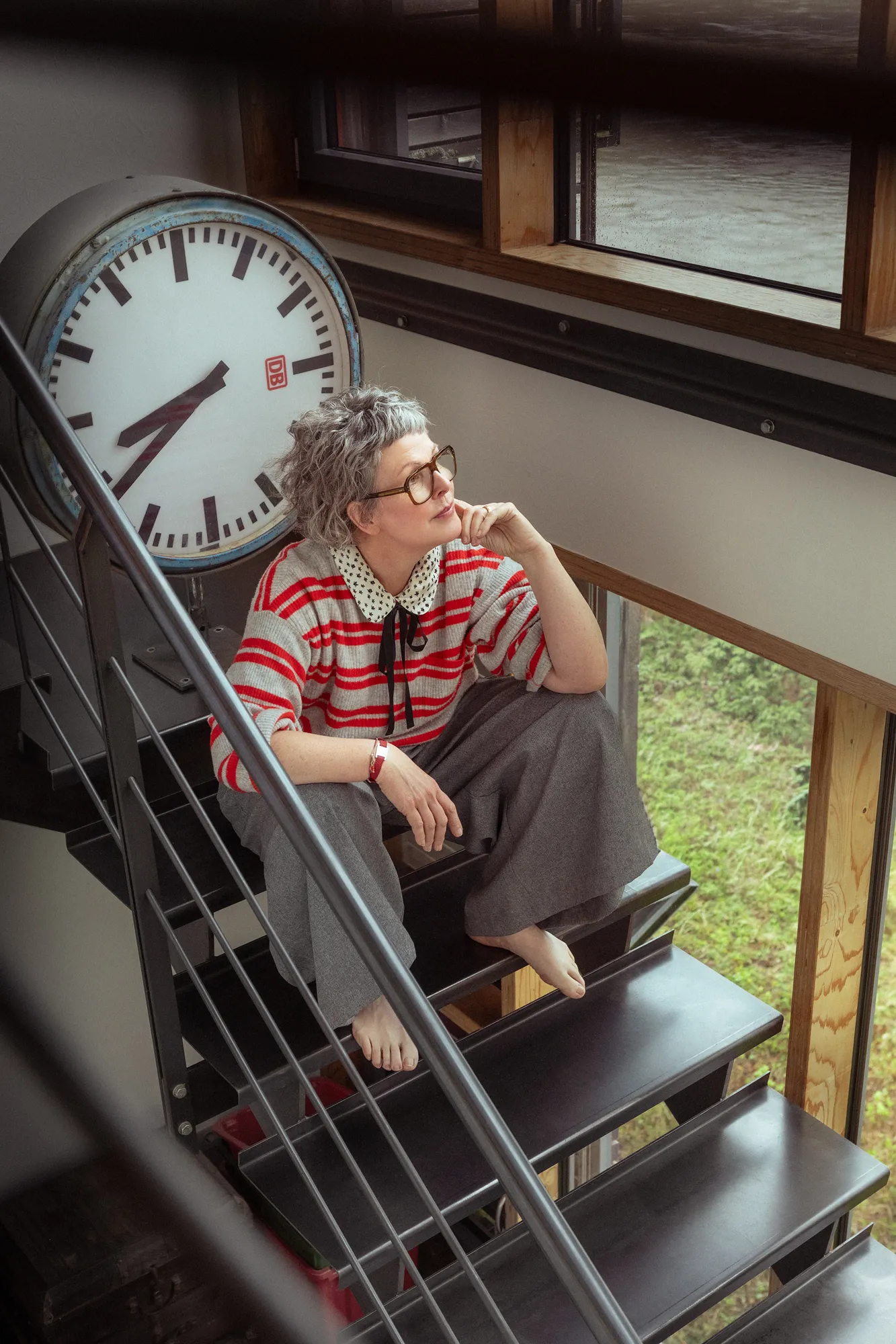Editorial portrait beneath a station clock