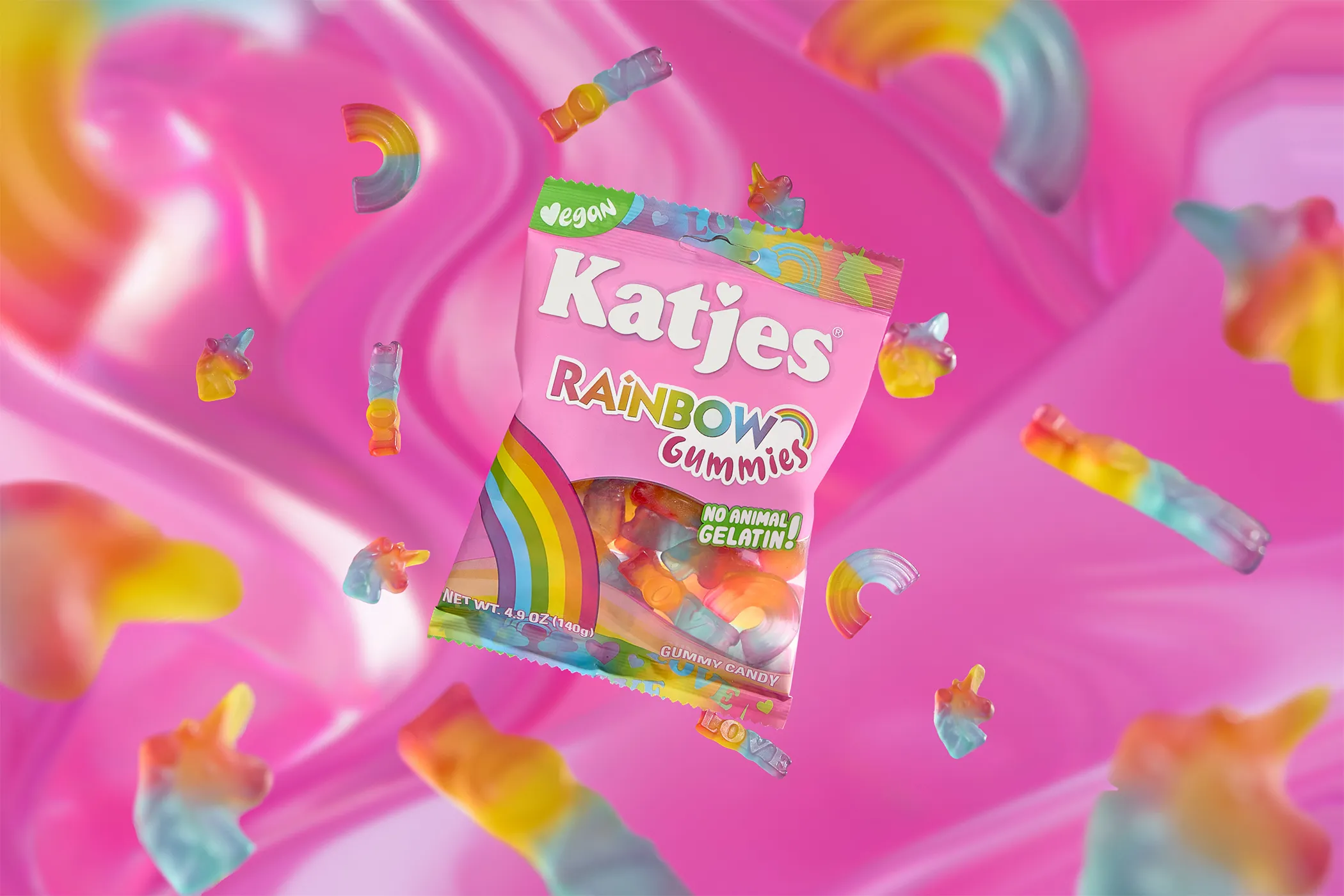 Katjes Rainbow Gummies pack suspended among unicorn and rainbow sweets on glossy pink